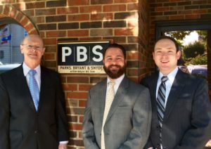 Attorneys Houston Parks, Wes Bryant, and Shawn Snyder in front of the Columbia, Tennessee offices of Parks, Bryant and Snyder, PLLC